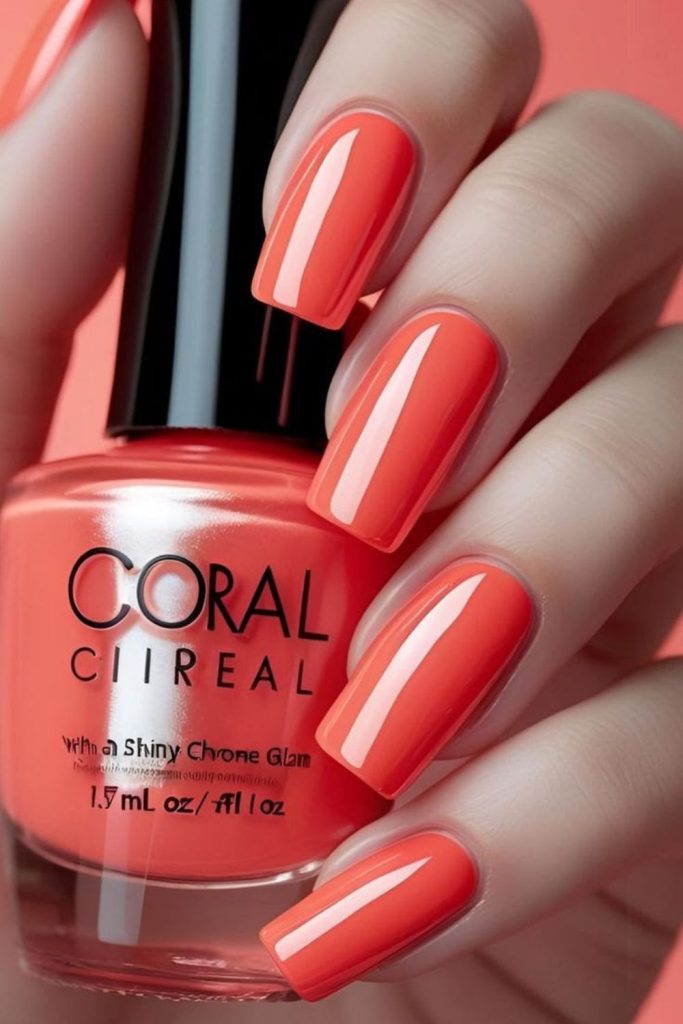 Bright coral glossy summer school nails.
