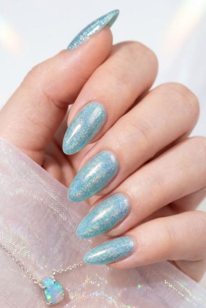 Crystal aqua glitter summer manicure style.