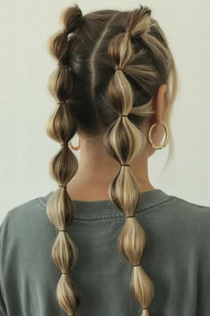 Double bubble braids playful hairstyle.