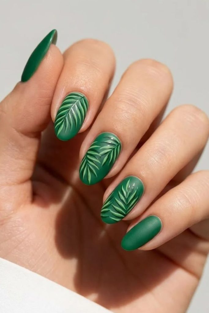 Emerald palm leaf nail art.