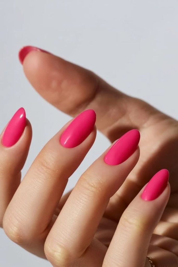 Flamingo pink glossy summer manicure style.