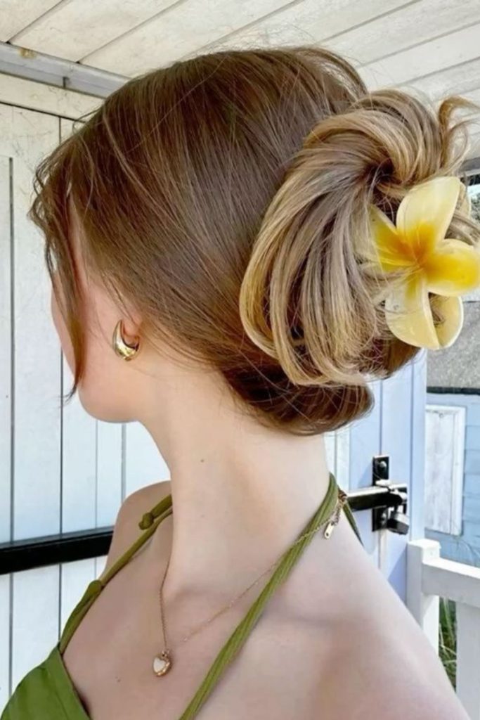 Floral clip low bun hairstyle.