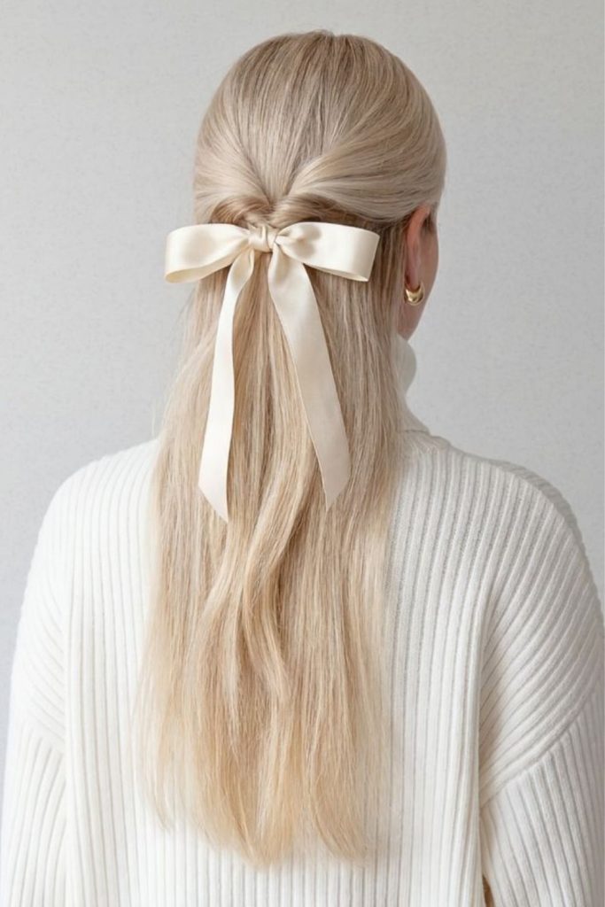 Straight hair with flowing ribbon detail.