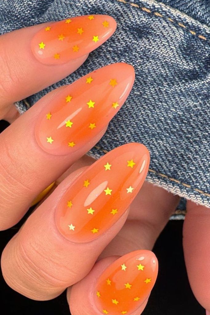 Golden citrus orange sparkling nail style.