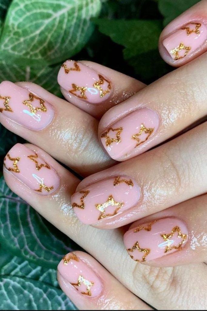 Golden star blush student nail design.