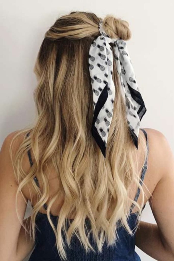 Half-up hairstyle with patterned bandana.