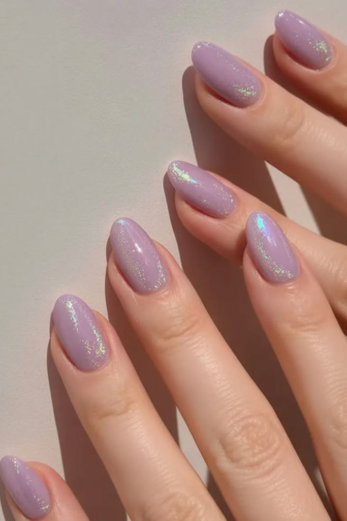 Soft lavender nails with shimmer accents.