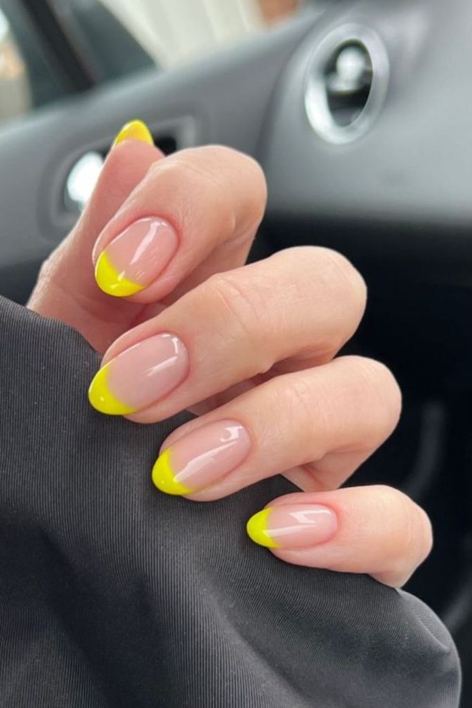 Yellow French tip almond nails.