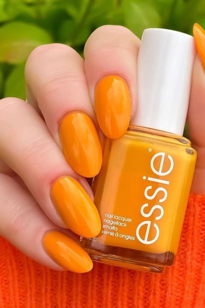 Mango orange glossy summer manicure style.