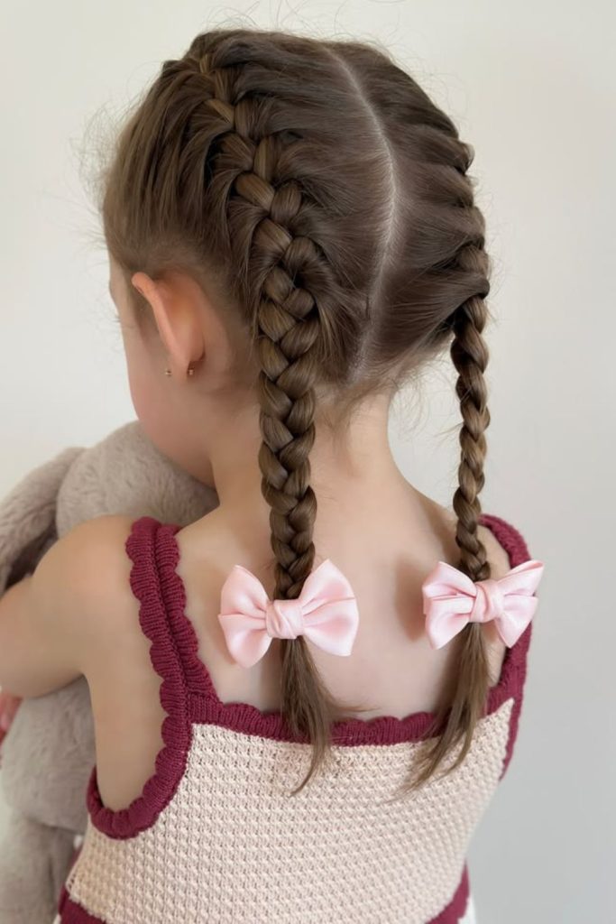 Dutch braids finished with pretty bows.