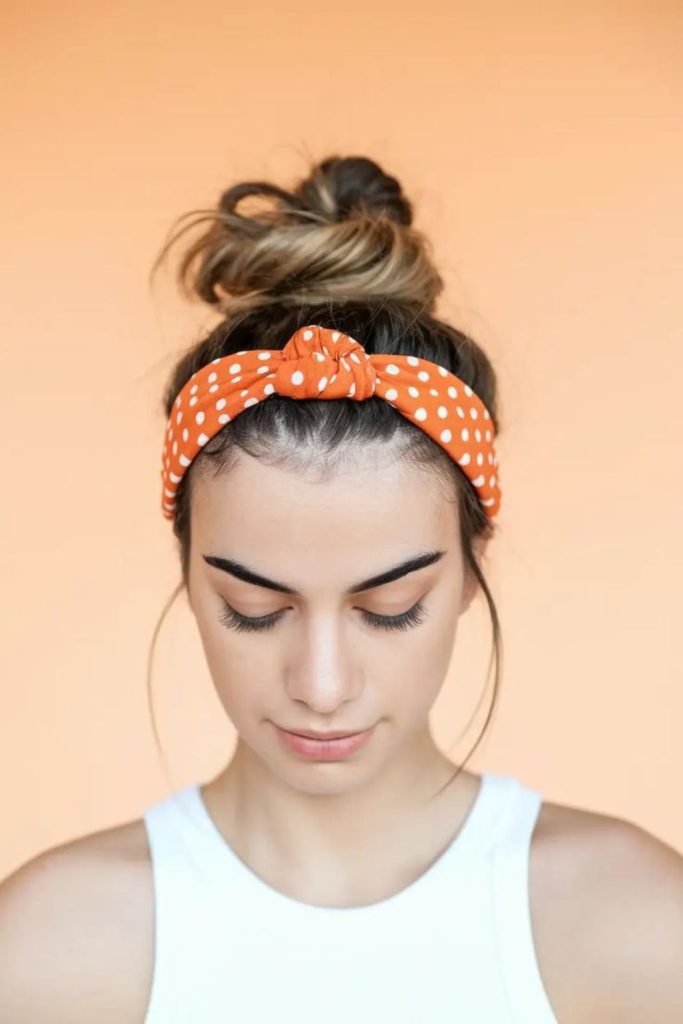 Chic mini top knot hairstyle.
