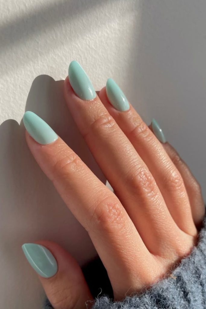Mint green glossy fresh school manicure.