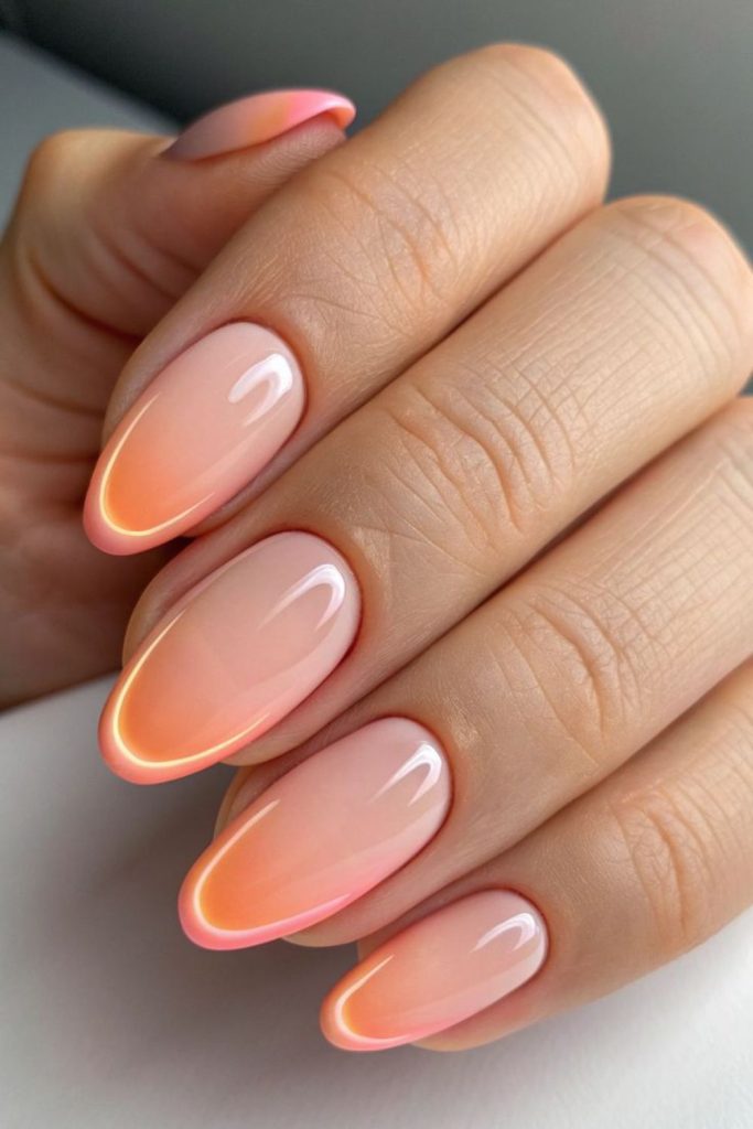 Neon peach glossy summer nails.