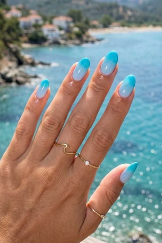 Blue ocean ombre beach-inspired nails.