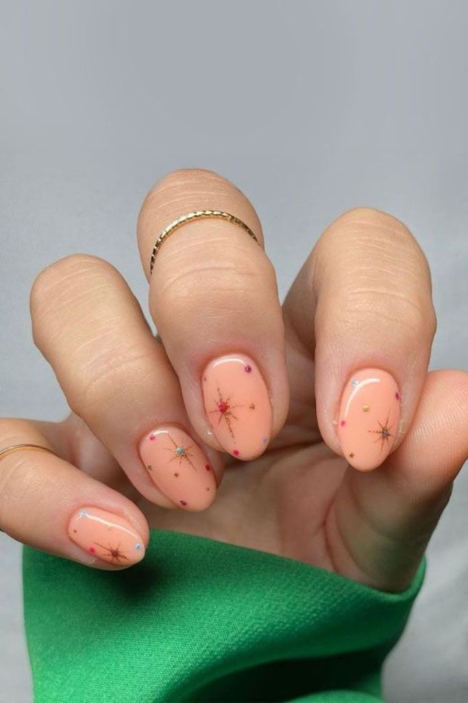 Soft peach nails with gold.
