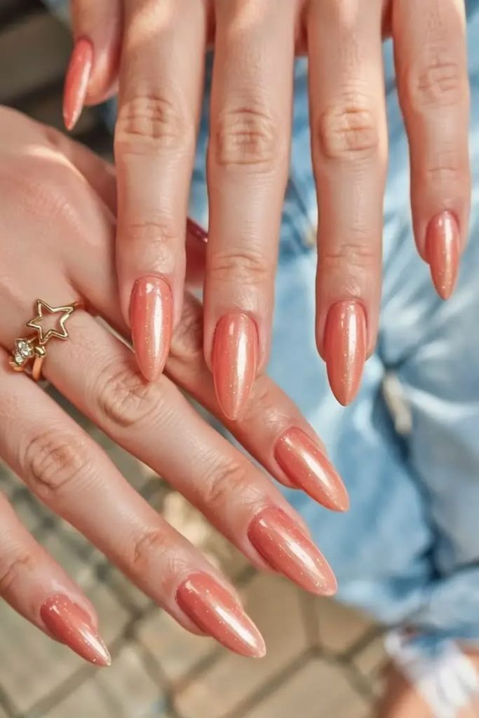 Peach champagne glitter almond nails.