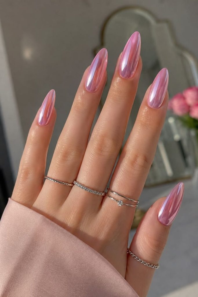 Pink chrome nails with crystal accents.