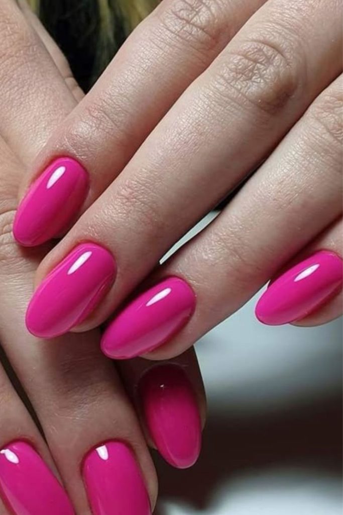 Bright pink highlighter-inspired school nails.