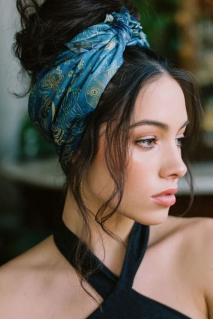 Ribbon-fold bandana across sleek hairstyle.