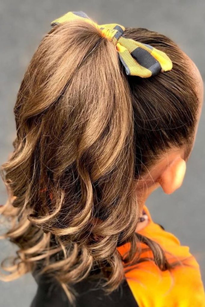 High pony wrapped with ribbon.