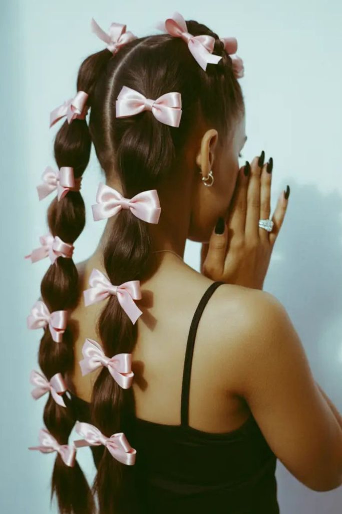 Bubble ponytail decorated with satin ribbons.