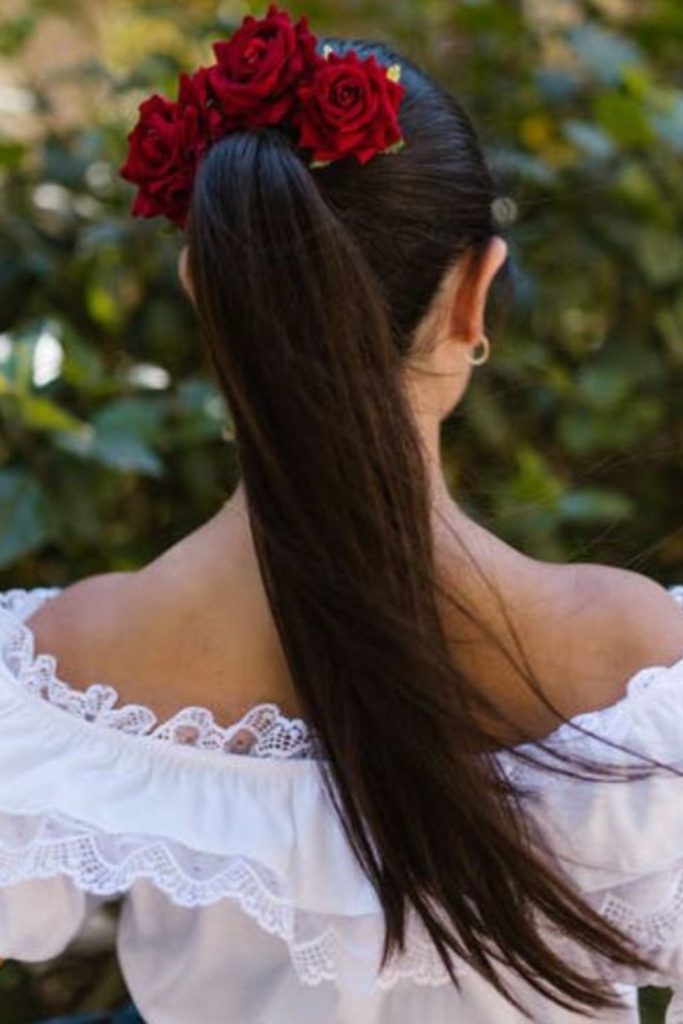 Scarlet bloom low ponytail hairstyle.