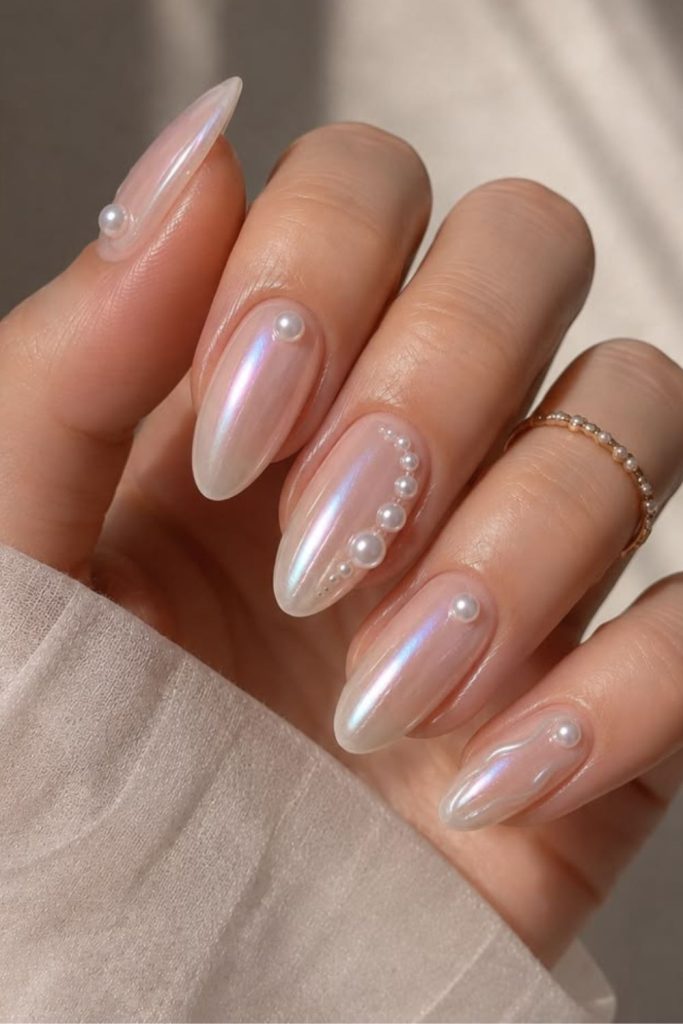 Pearly seashell inspired glossy nail design.