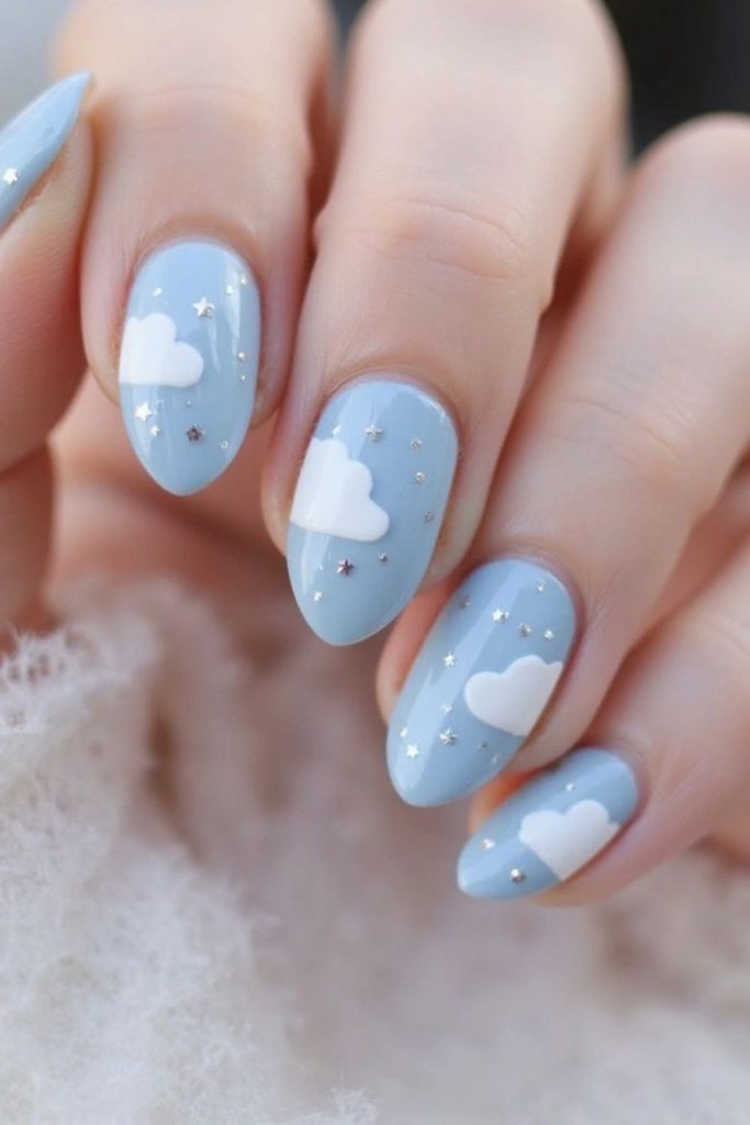 Baby blue nails with white clouds.