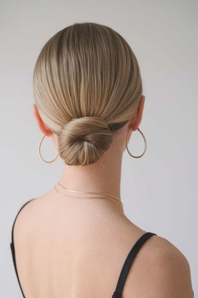 Sleek low micro bun hairstyle.