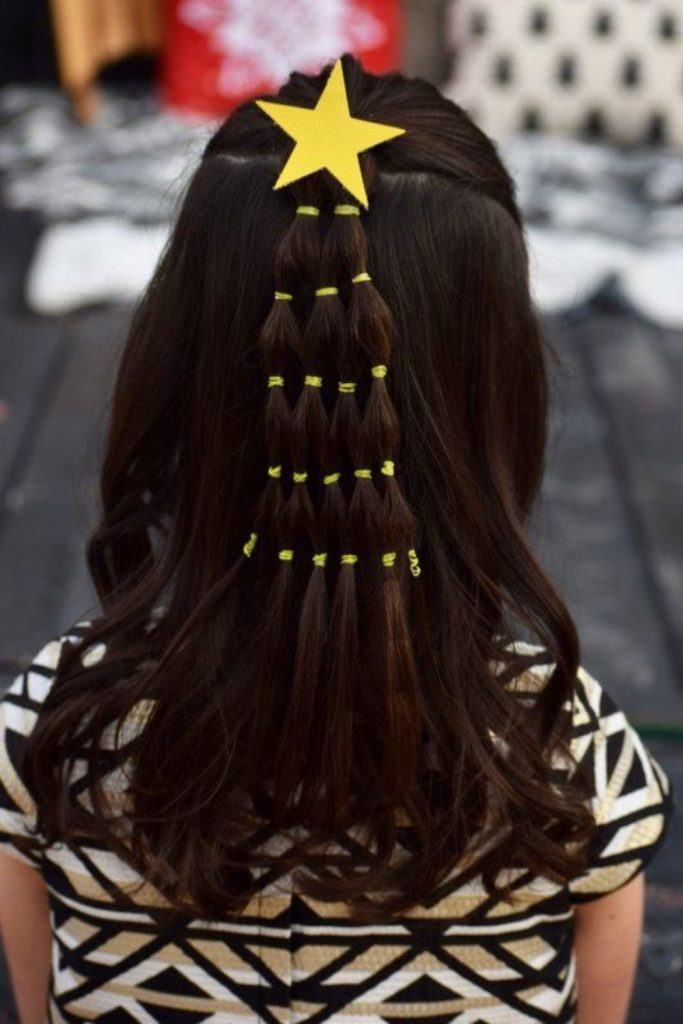 Half-up hairstyle with star clips.