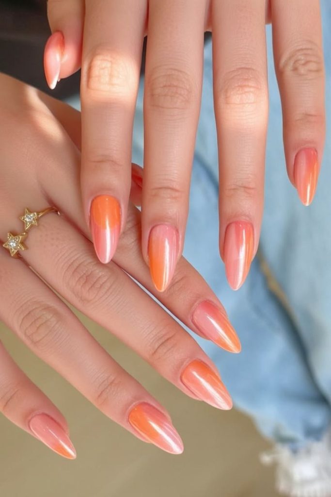 Soft apricot nails with gold foil accents.