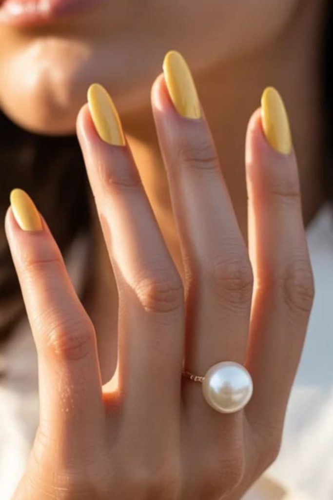 Bright lemon glossy summer nail design.