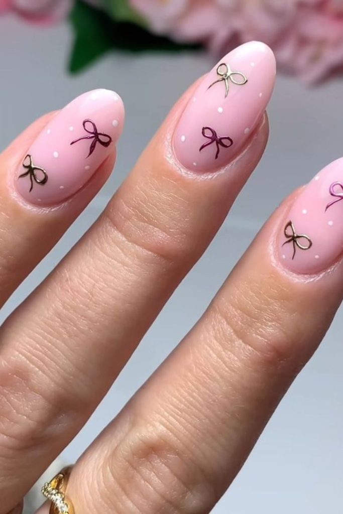 Pink nails with tiny bows.