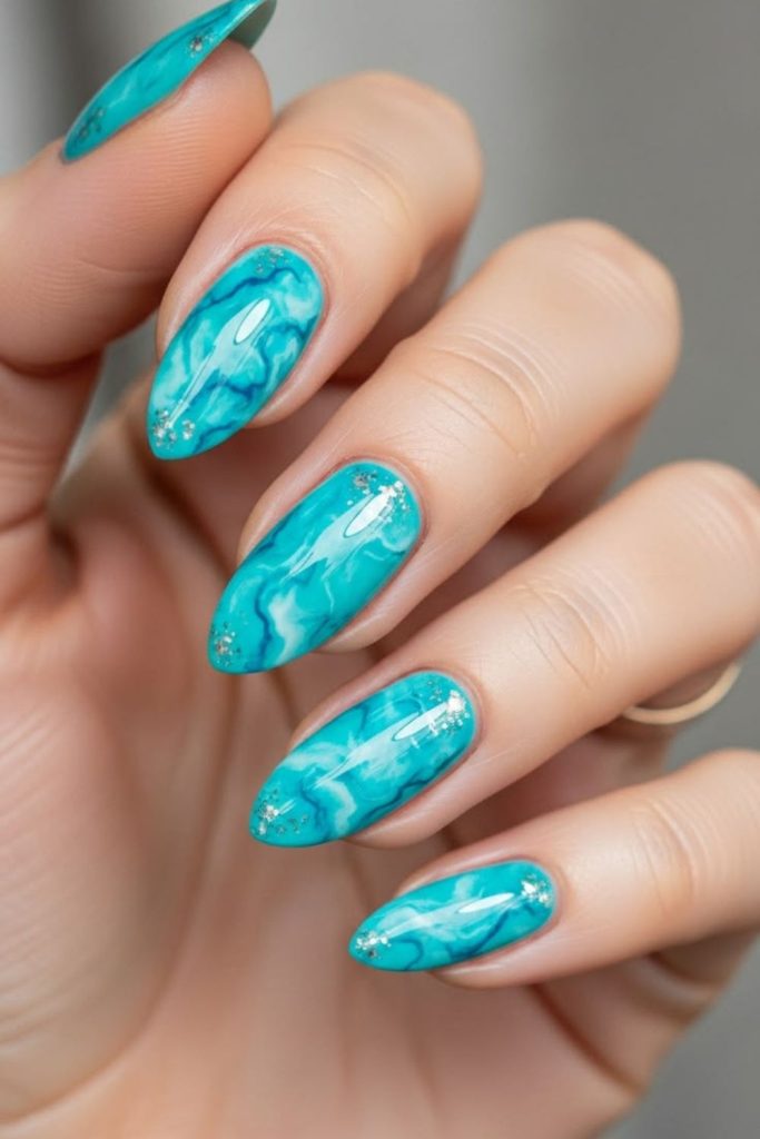 Tropical lagoon marble nail art.