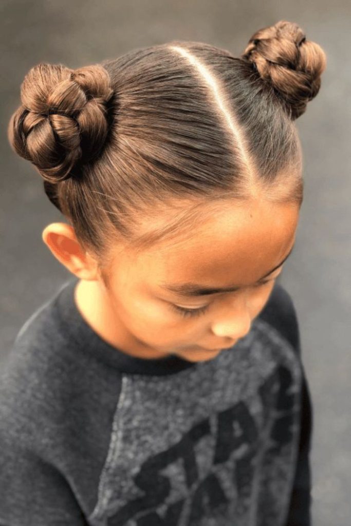 Twisted double buns with clips.