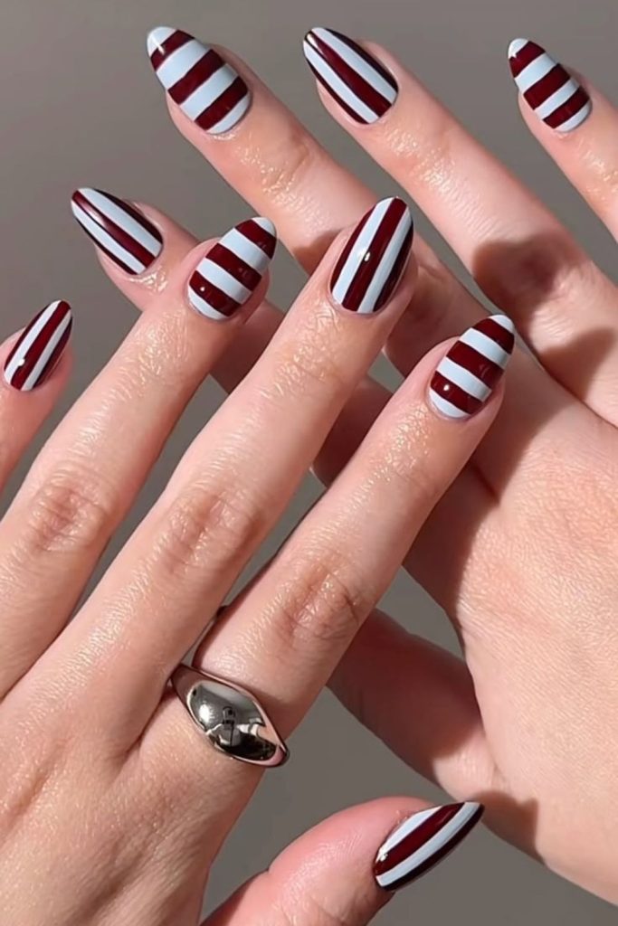 Varsity stripe nails in burgundy.
