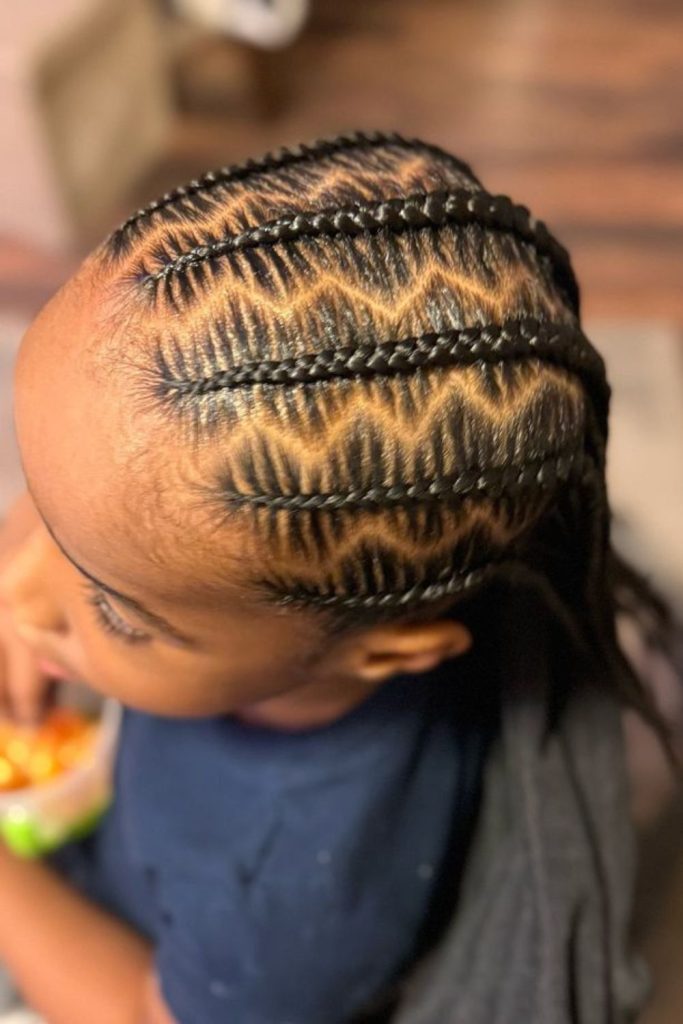 Zigzag cornrows with stylish patterns.