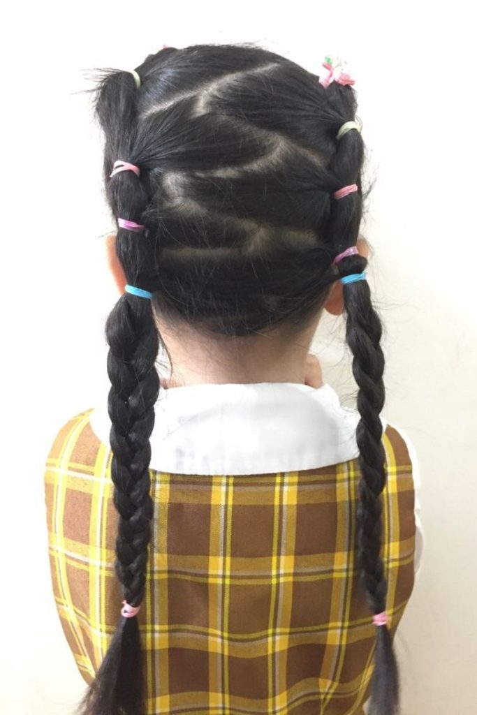 Zigzag part with playful pigtails.