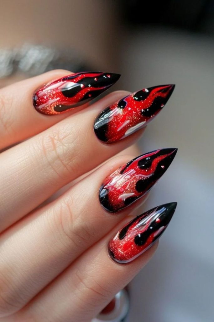 Burgundy nails with bewitched flame designs.