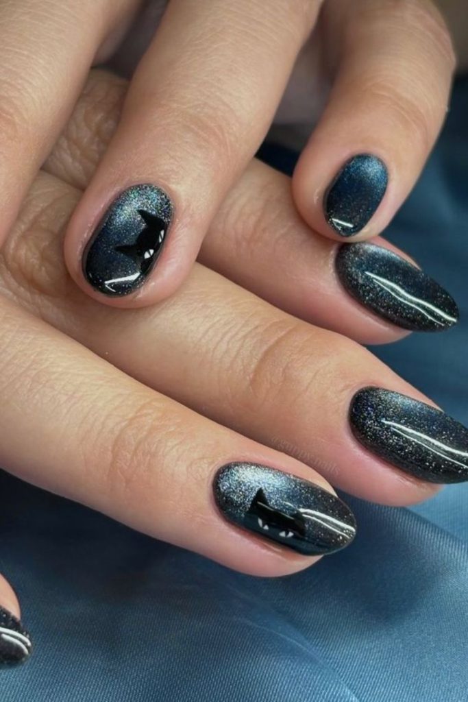 Black cat nails with crescent moons.