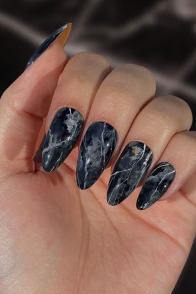 Black marble nails with silver veins.