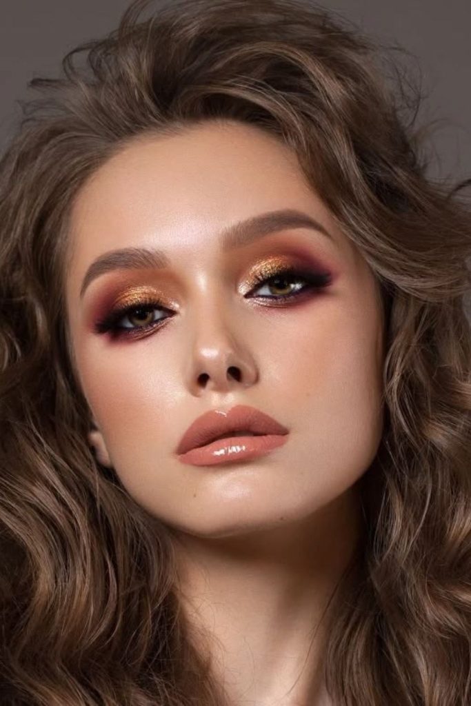 Bronze smoky dramatic eye makeup.