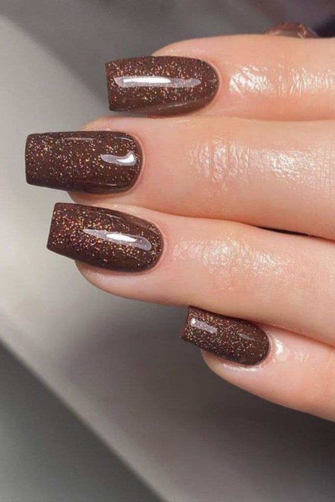 Brown sugar sparkle nail design.