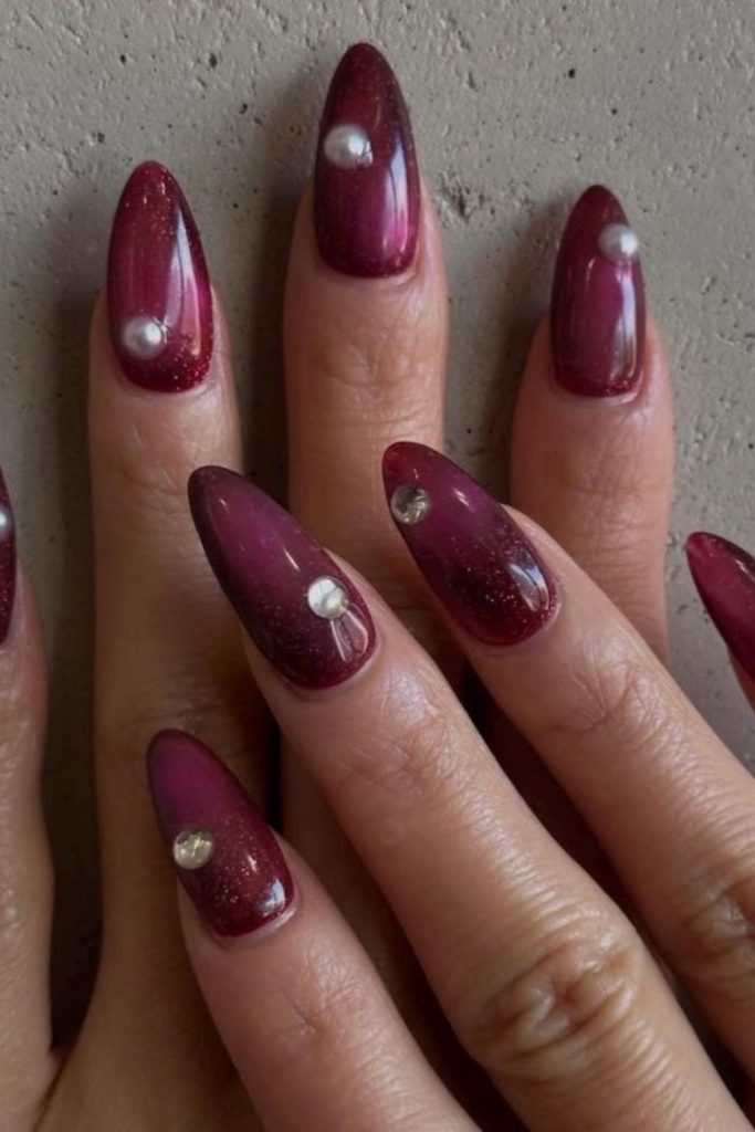 Sparkling oxblood gemstone manicure design.