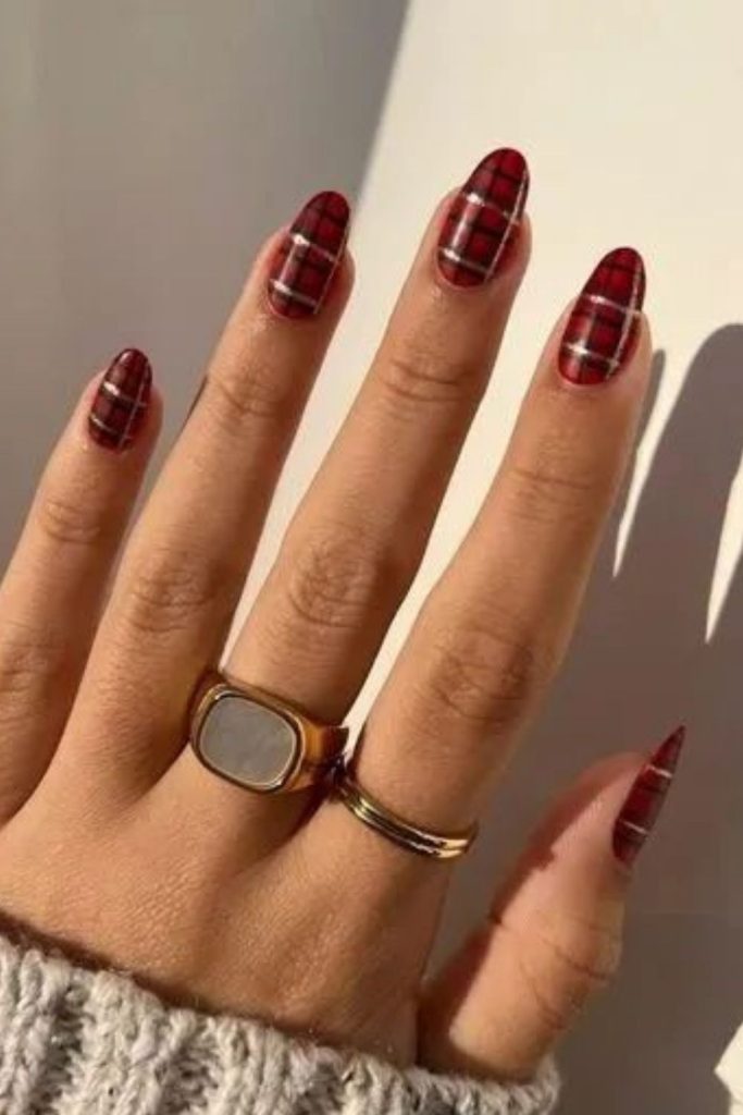 Burgundy velvet plaid nail design.
