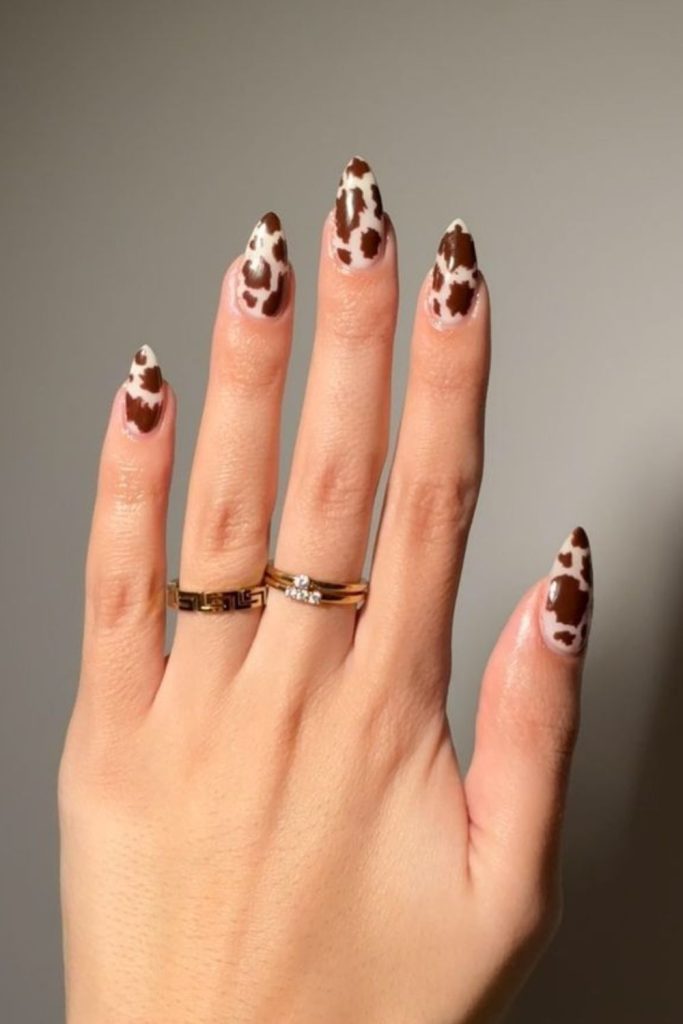 Chocolate cow print nail design.