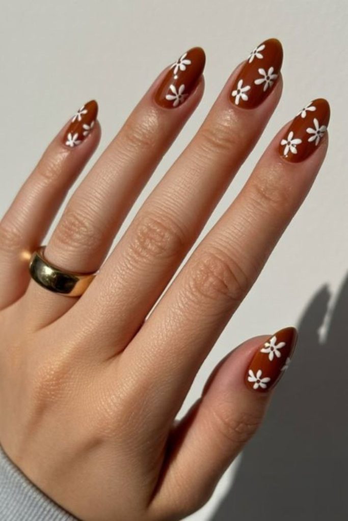 Chocolate brown floral manicure design.
