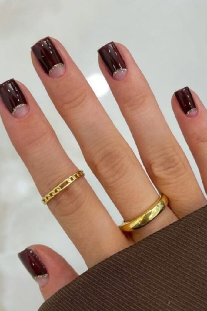Chocolate brown half-moon nails.
