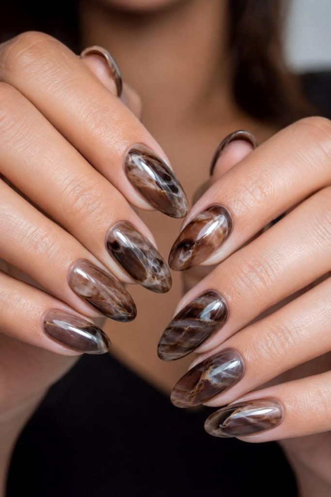 Chocolate brown marble manicure design.