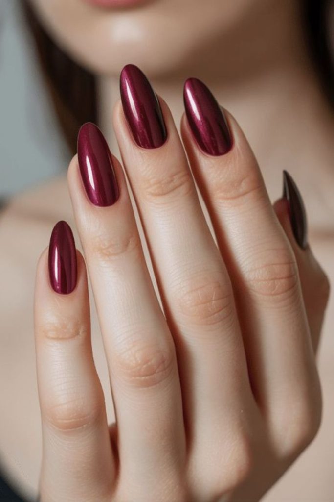 Metallic chrome oxblood almond nails.
